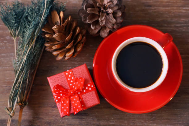 istock Red gift box and espresso coffee cup decoration with pine cone with keyboard on background. 1041280524