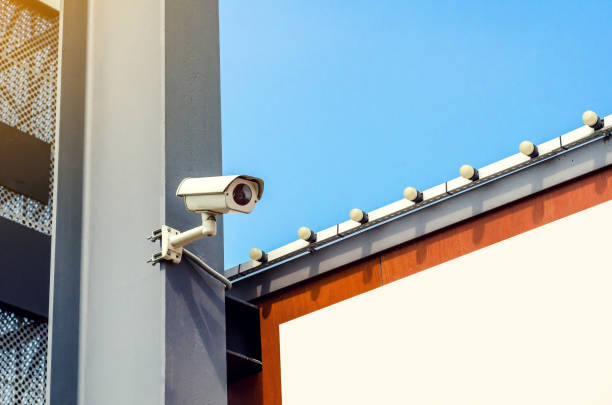 istock Surveillance camera is installed on a gray beam, parking a supermarket 1041281772