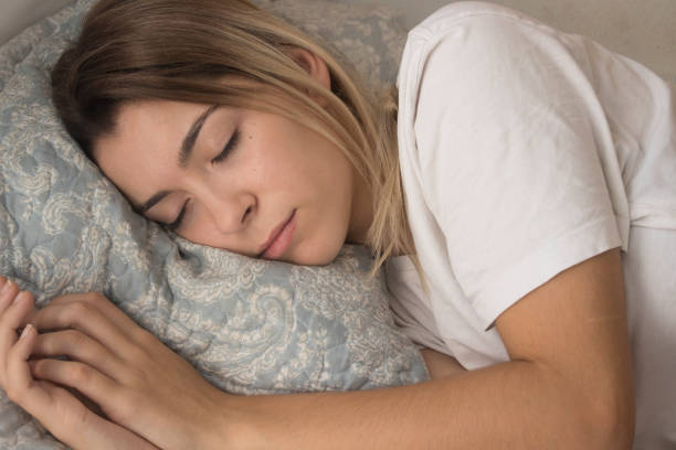istock pretty young girl sleeping in her room 1041286332