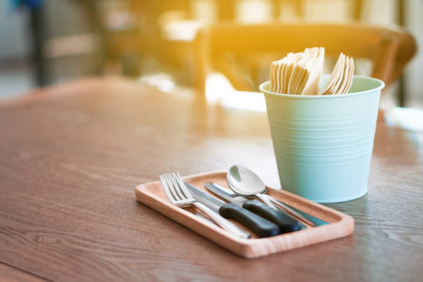 istock Cutlery on wooden table.Tissue paper.Spoon and fork. 1041287732