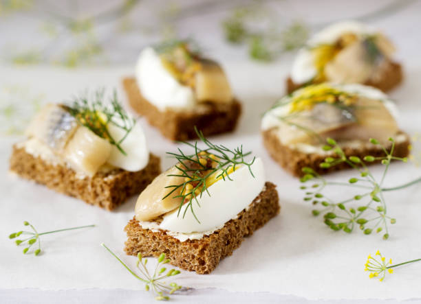 istock Tradition Danish open sandwich smorrebrod with herring, egg, mustard and dill. Dark bread sandwich. 1041294388