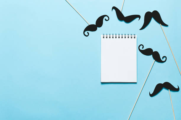 istock Many black paper Mustache on yellow background. 1041319114