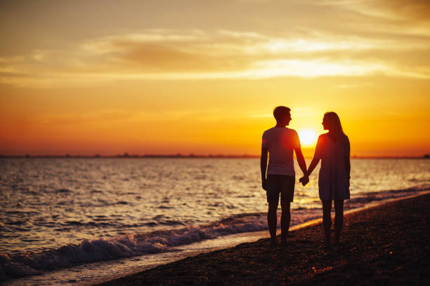 istock Young happy couple on seashore. 1041326274