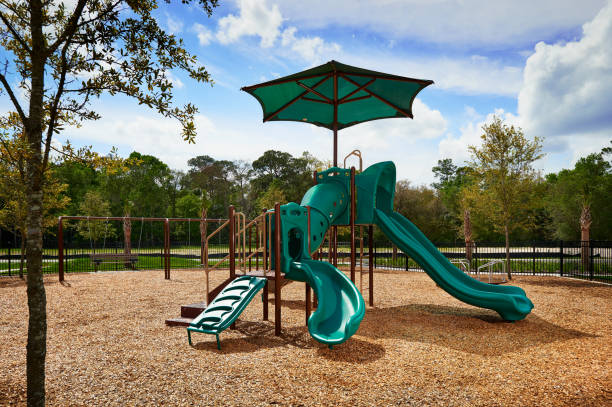 A Small, Green Playground Outside on a Sunny Day stock photo