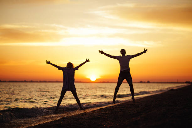 istock Young happy couple on seashore. 1041331348