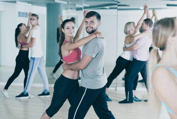 istock smiling young adults dancing salsa 1041334212