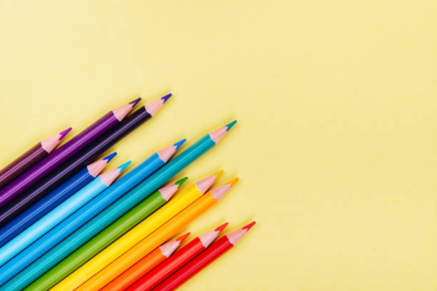 istock Color pencils in a row on yellow background. 1041338692