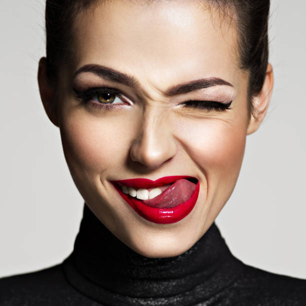 istock Young woman with bright face expression. Girl winks one eye 1041343020