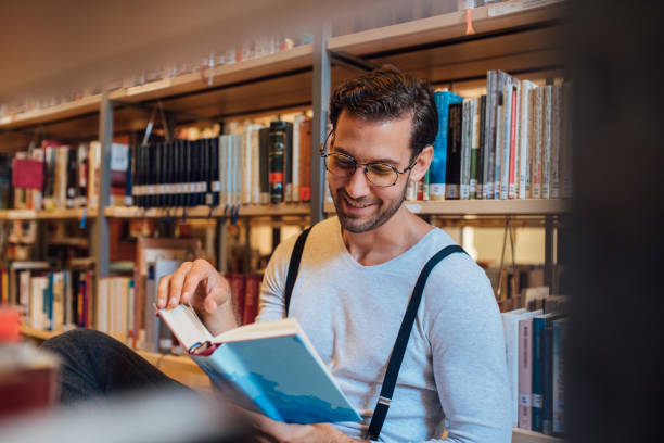 istock Young man studying in the library 1041347034
