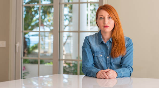 istock Redhead woman at home with a confident expression on smart face thinking serious 1041347586