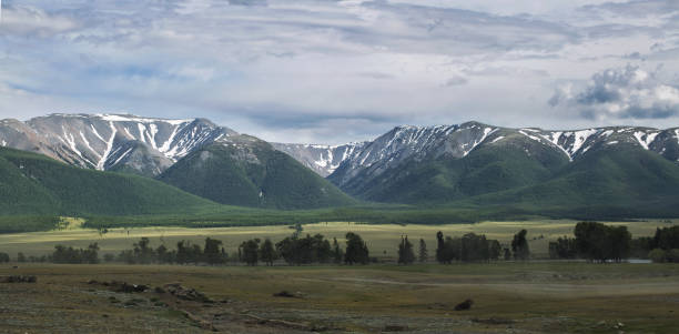 istock green hills and high snowy mountains 1041353006