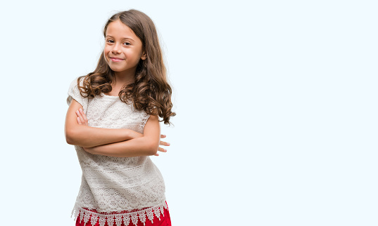 Brunette hispanic girl happy face smiling with crossed arms looking at the camera. Positive person.