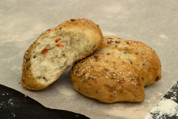 istock Bun with sesame and carrots on baking paper 1041363098