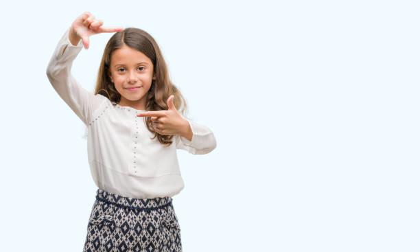 istock Brunette hispanic girl smiling making frame with hands and fingers with happy face. Creativity and photography concept. 1041364540