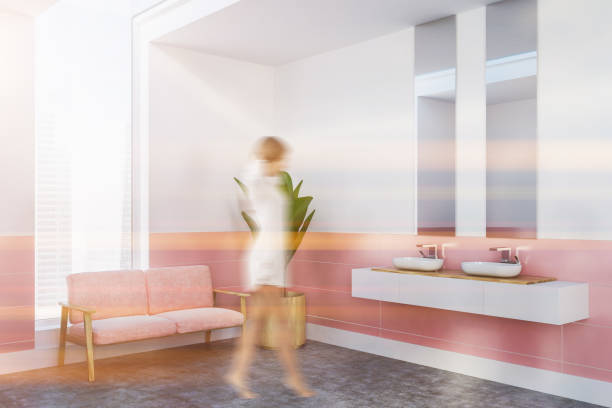istock Pink sofa bathroom interior, double sink, woman 1041371860