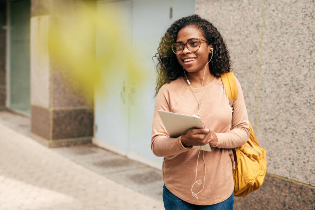istock International student with backpack, headphones and digital gadgets 1041372898