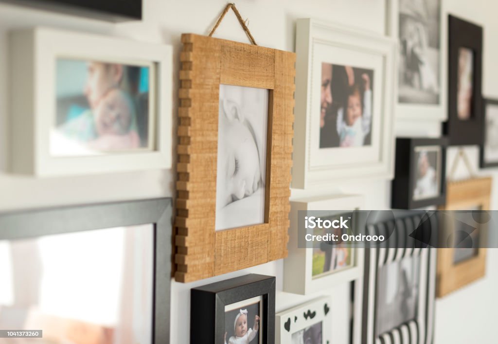 photos of the family in various photo frames white wall with photos of the family in various photo frames Photograph Stock Photo