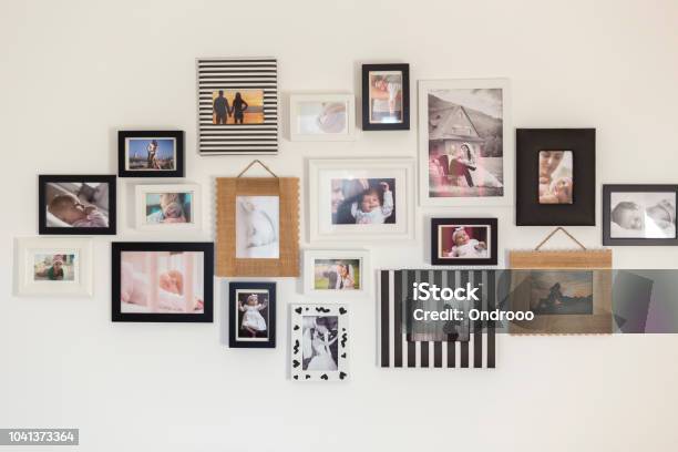 Photos Of The Family In Various Photo Frames Stock Photo - Download Image Now - Photograph, Photography, Wall - Building Feature