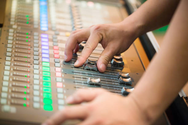 istock DJ controlled the sound system by mixer equalizer in concert or wedding hall. image for background, and copy space. 1041376692