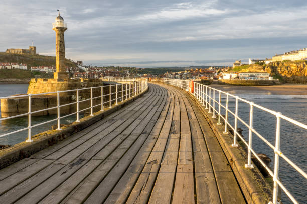 Inside the lower tier of the harbour wall looking out. Bright autumn day. Whitby, North Yorkshire, United Kingdom, September 7, 2019