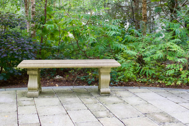 istock Ornate stone park bench with green surroundings 1041384646