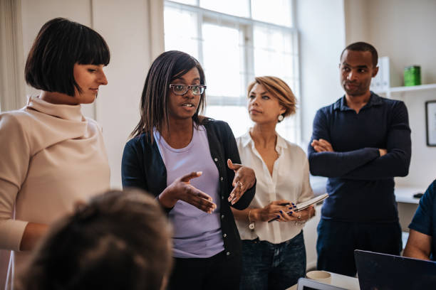 istock Black female leader presenting the project to colleagues 1041394346