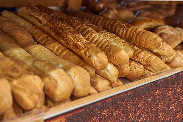 The baguettes on the shelf in the supermarket.