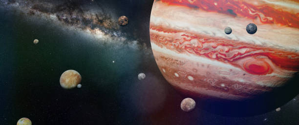 planet Jupiter with some of the 69 known moons with the galaxy stock photo