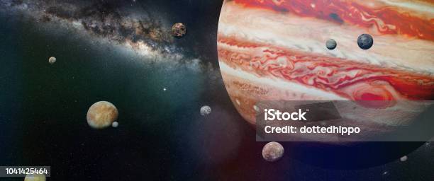 Planet Jupiter With Some Of The 69 Known Moons With The Galaxy Stock Photo - Download Image Now