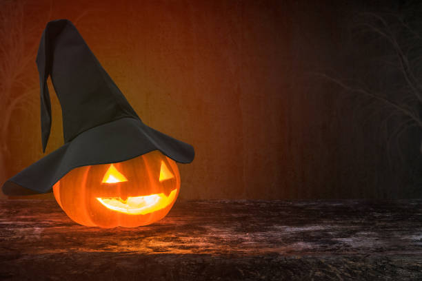 istock Halloween pumpkin Jack O'Lantern smiling face on grunge wood background 1041460102