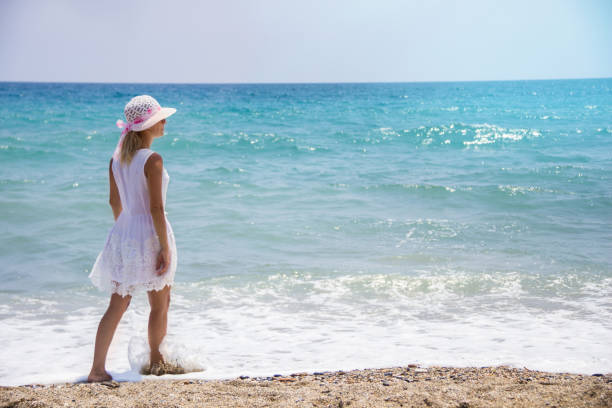 istock Lonely young woman walking on the beach 1041460124
