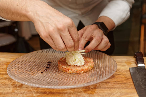 istock Chef is cooking salmon tartar with cut apple 1041460242