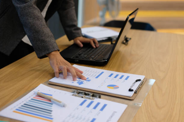 istock financial inspector analyze document at office. businesswoman working with computer at workplace 1041460312