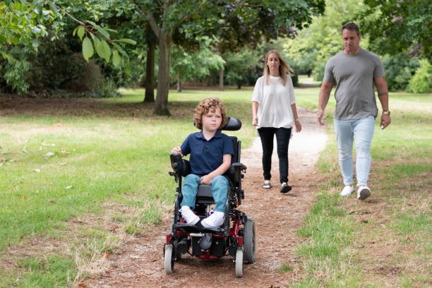 istock Boy operating wheelchair in park with parents 1041470868