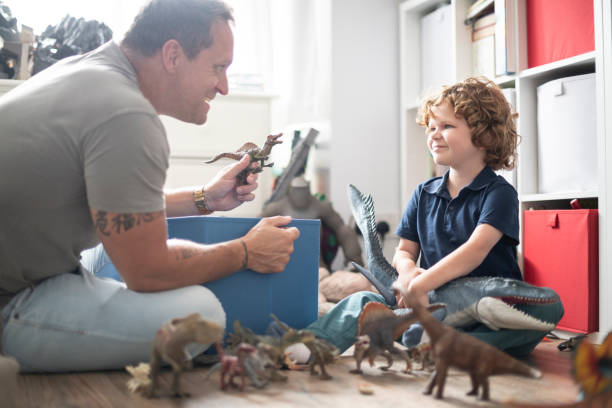 istock Boy playing with toys with his father 1041472056