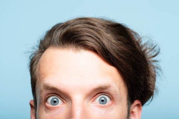 istock startled eccentric man head peek out crazy look 1041476000