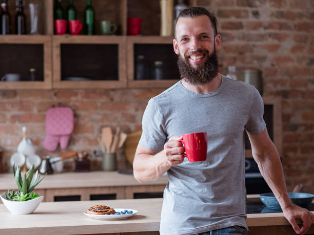 istock traditional breakfast tea kitchen man red mug 1041476114