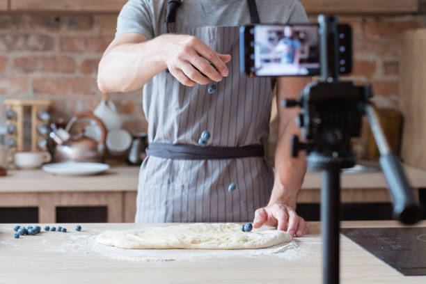online culinary show blog video stream chef cook online culinary show. blogging aÑв live video streaming. chef showing the process of pie cooking. cooking show stock pictures, royalty-free photos & images