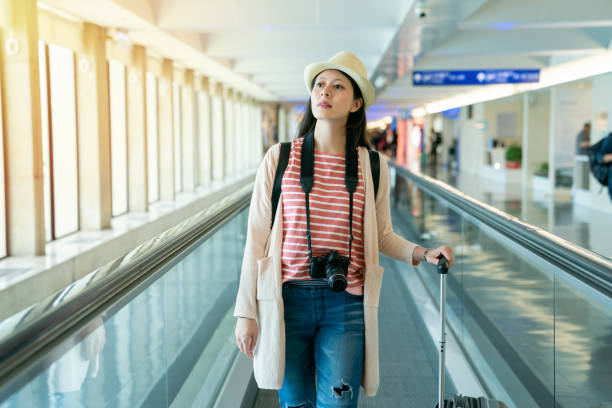 istock pretty female standing on movable conveyor. 1041477886
