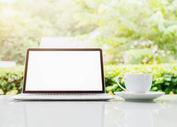 istock Laptop computer and cup of coffee on the table in morning 1041483344