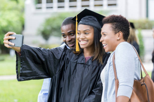 istock College graduate taking selfie with parents 1041483864