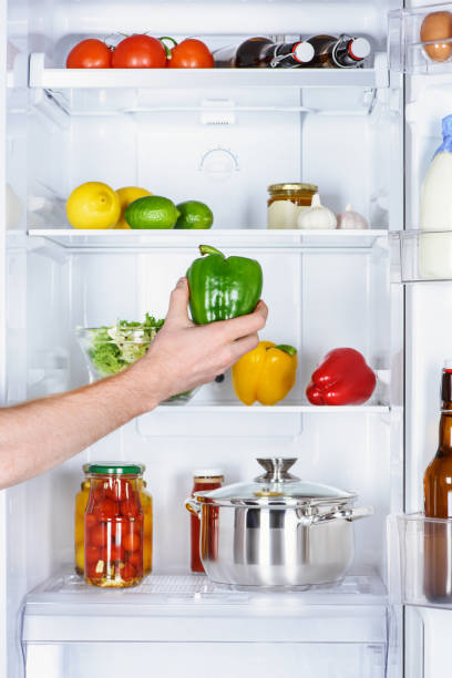istock cropped image of man taking bell pepper from fridge 1041488276