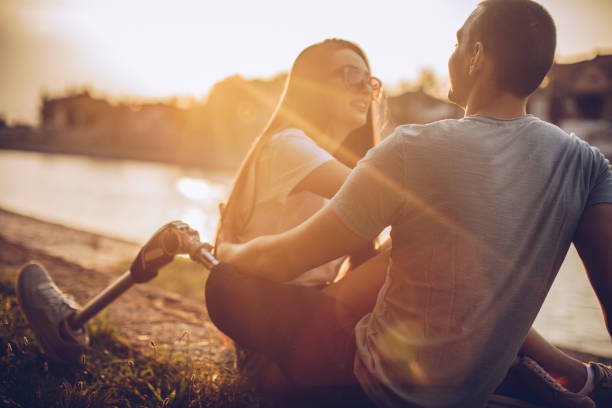 istock Couple relaxing by the river 1041489630