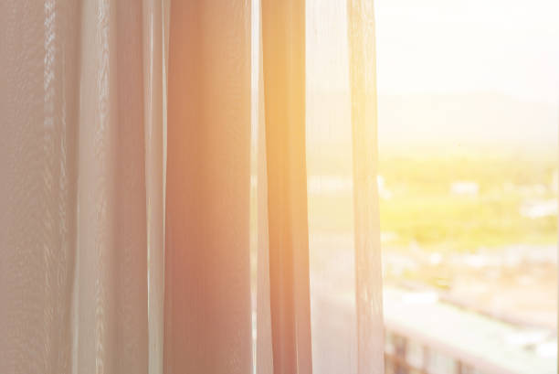 istock white curtain slightly open in the comfortable room for background 1041490324
