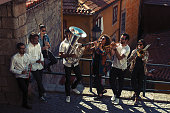 Jazz band a group of musicians with wind instruments playing on the street of the city.