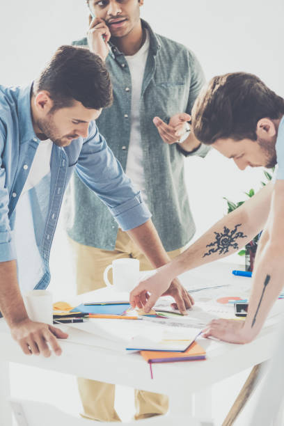 istock young multiethnic businessmen working with papers in office, business teamwork concept 1041494258