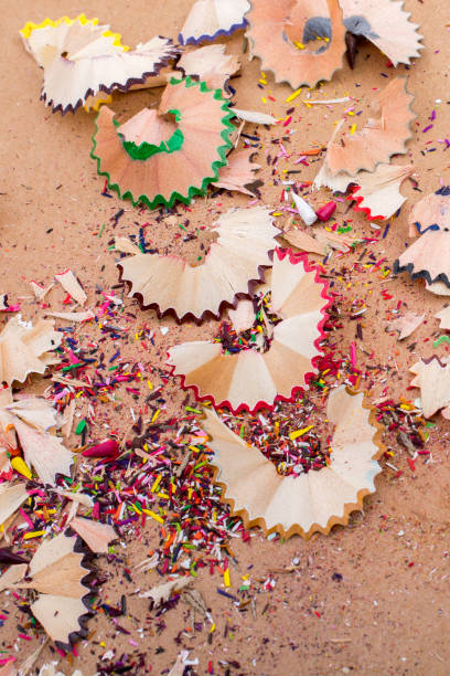 istock Colorful pencil shavings on brown background 1041502850