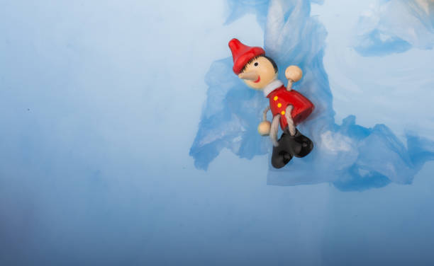 istock Hand holding Pinocchio on in  water 1041502864