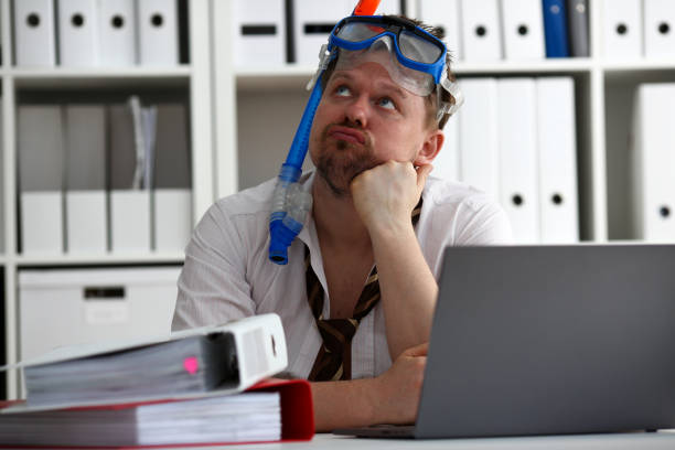 istock Man wearing suit and tie in goggles with snorkel 1041504692