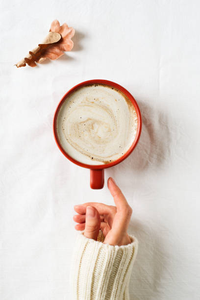 istock Minimalism composition with cup of coffee and hand 1041509898